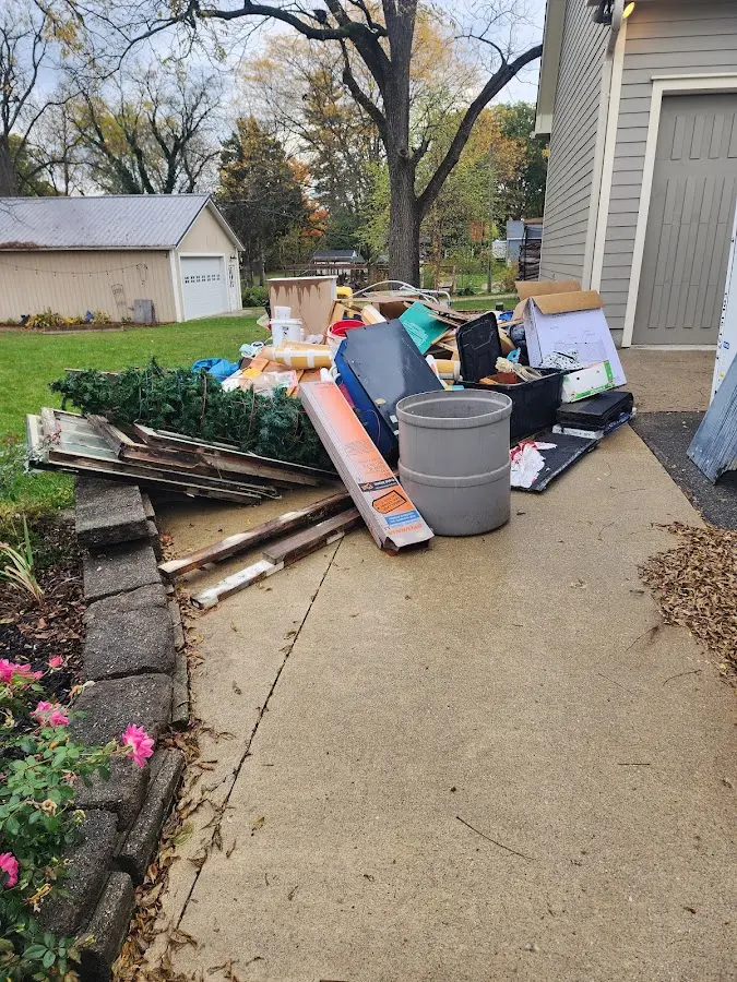 Dumpster being loaded with debris for Estate Cleanout Dumpster Rental in Hampton